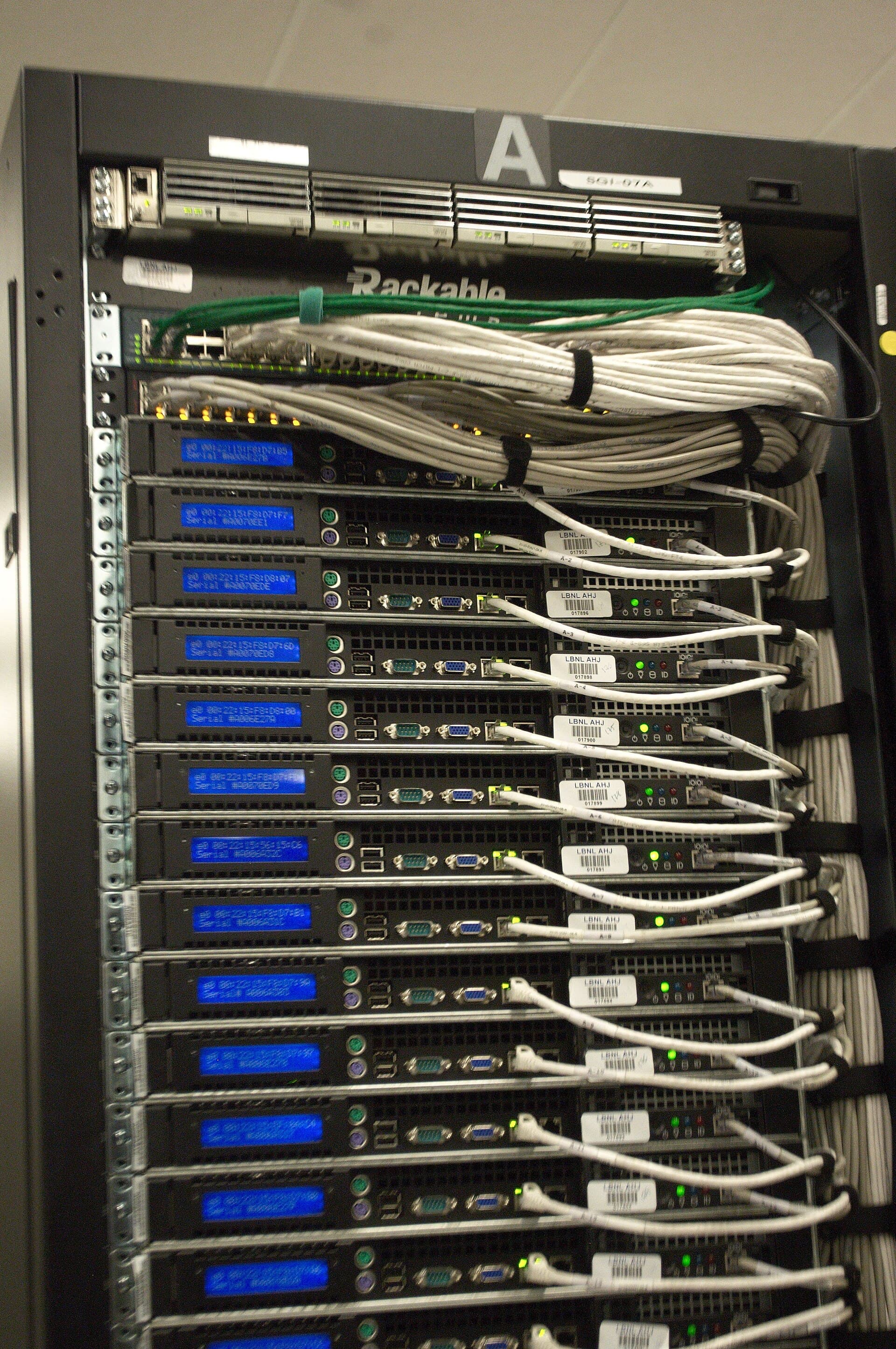 Rear of a data-centre server rack, with bundled network cables running between machines